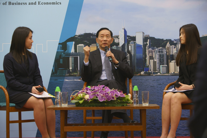 Mr. Peter Wong Tung Shun answers audience’s questions in a Q&A session moderated by two Student Ambassadors: Miss Christy Yeung, Year 2 Bachelor of Economics and Finance student (left) and Miss Ann Ko, final year students of Bachelor of Business Administration in Accounting and Finance (right).