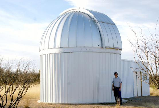 Thomas G. Kaye standing next to the Raemor Vista Observatory in southeastern Arizona USA. This telescope provides rapid response optical followup for newly discovered astronomical objects. It is currently being upgraded to a 1.1 metre telescope. Image Credit: Thomas G Kaye.
 